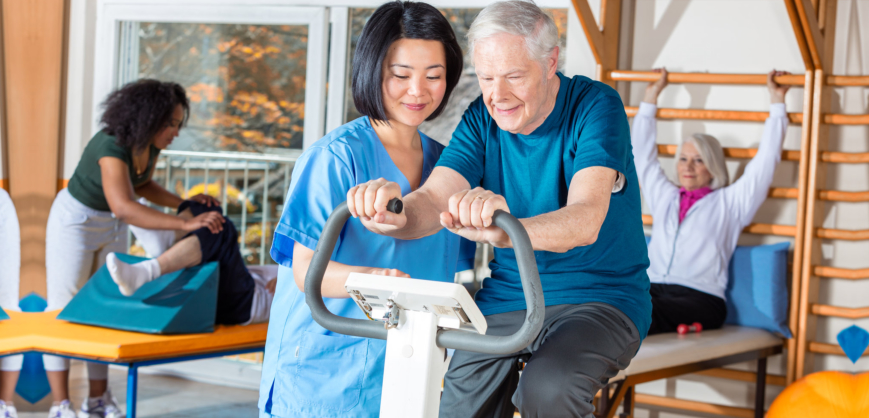 caregiver and elder man doing physical therapy