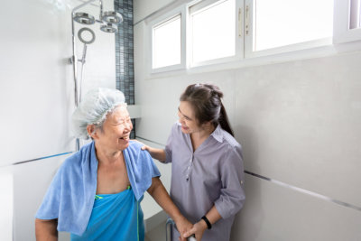 caregiver is assisting senior woman
